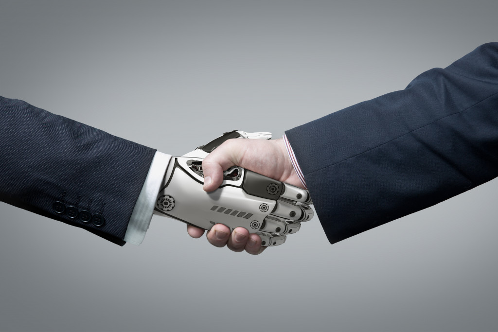 Business Human and Robot hands in handshake.