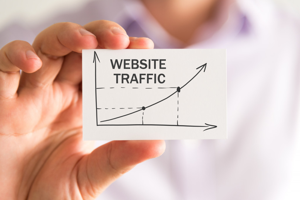 a businessman holding a piece of paper with a website traffic graph