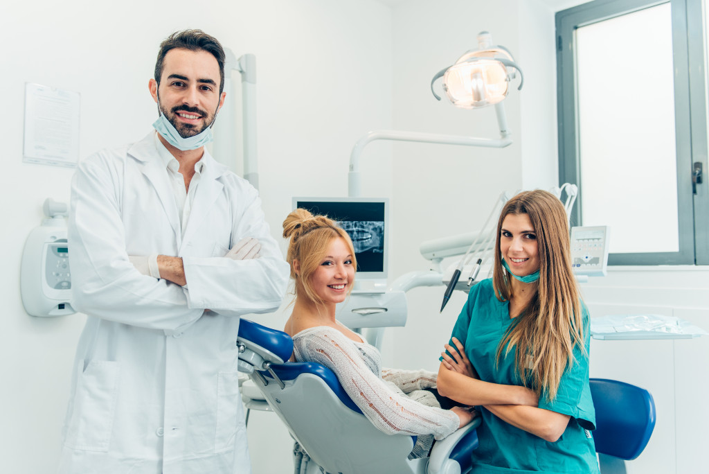dentist with his assistant and a patient